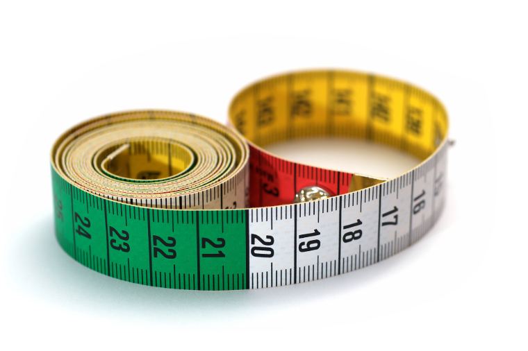 A coloured measuring tape rolled up